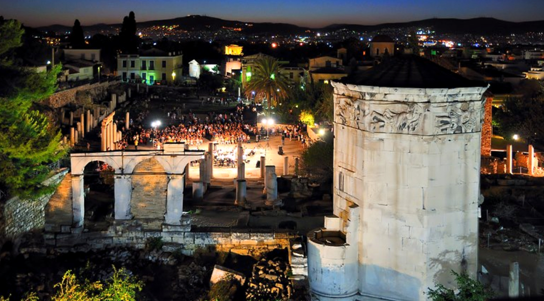 Nighttime Athens city view with Roman agora ruins in foreground