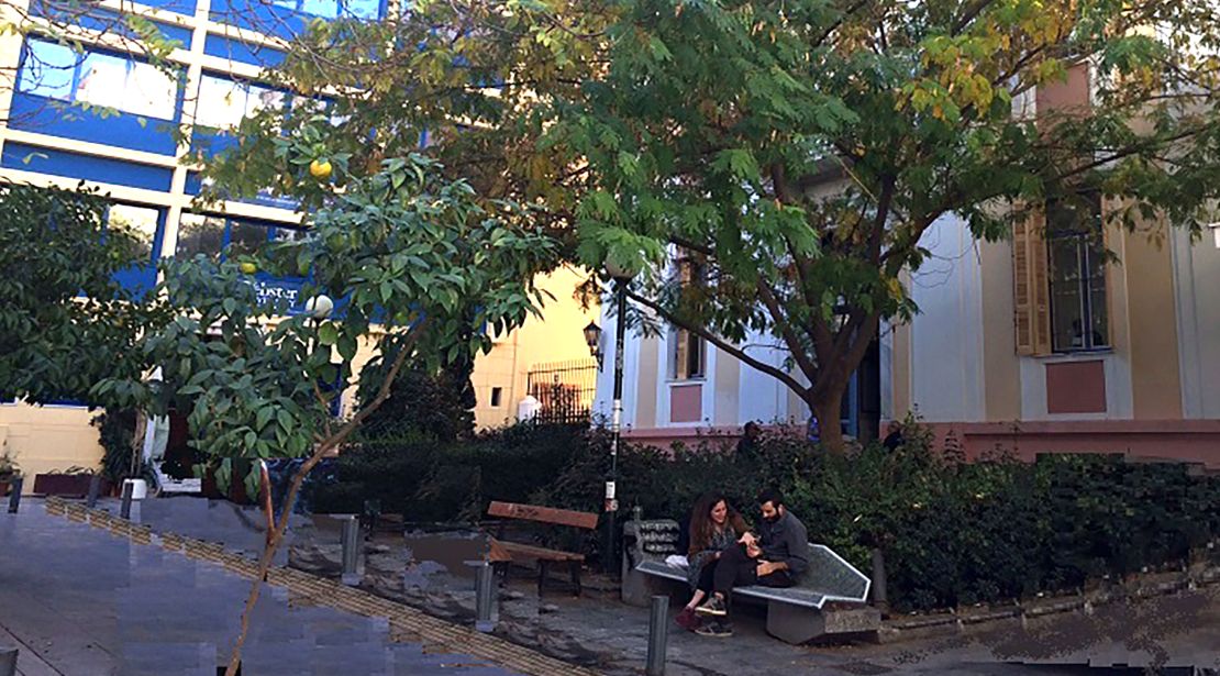 Students sitting on a bench on the Webster Athens campus
