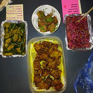 Three plates of finger food from different cultures.