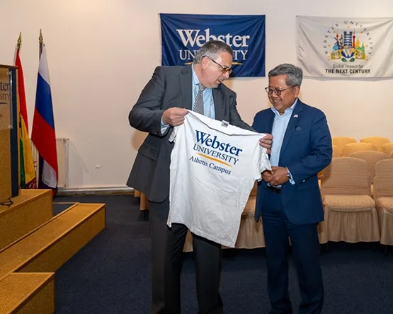 rector giving a Webster Athens t-shirt to the indonesian ambassador 
