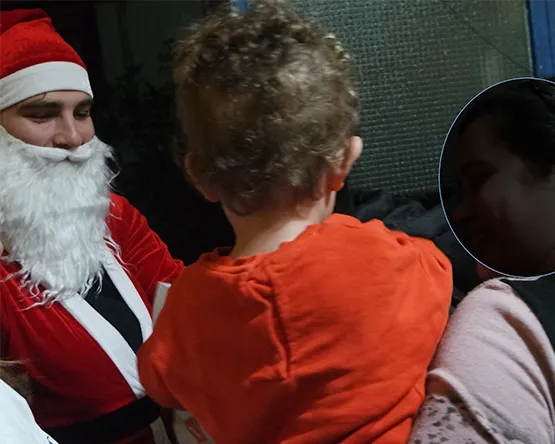 Santa is giving out gifts to children